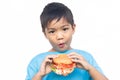 AsianÃ¢â¬â¹ childÃ¢â¬â¹ boyÃ¢â¬â¹ biting andÃ¢â¬â¹ eatingÃ¢â¬â¹ aÃ¢â¬â¹ hamburger.Ã¢â¬â¹ Fast food.Ã¢â¬â¹